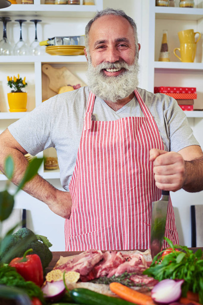 Caucasian man sticking a knife in a cutting board and starting p - Photo, Image