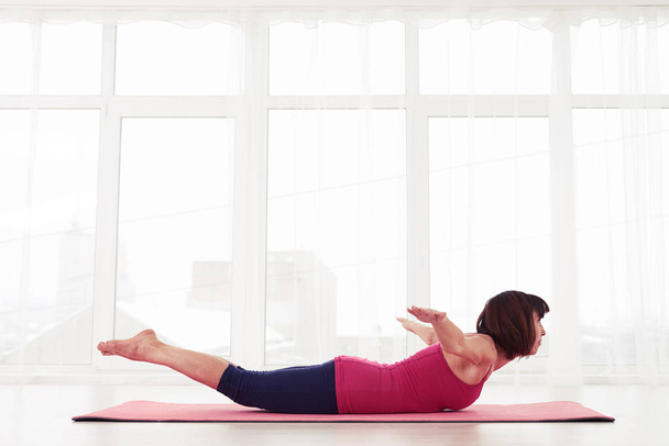 Koncentrovaný yogini praxe cvičení ohybu jóga nebo Kobra představovat  - Fotografie, Obrázek