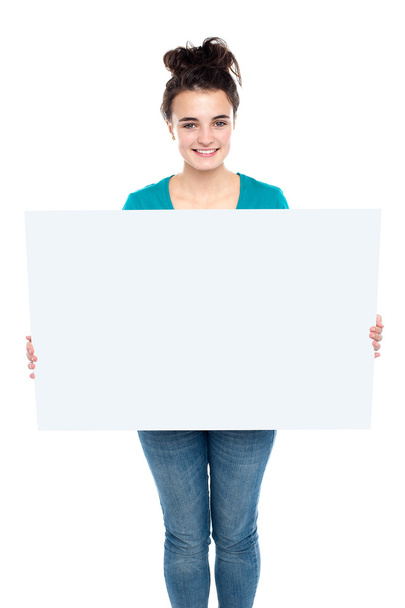 Adorable smiling teenager holding big ad board - Zdjęcie, obraz