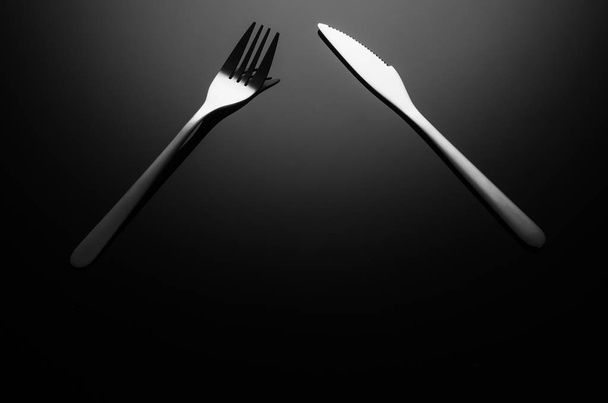 Black food background, silverware on reflective surface with copy space - Фото, изображение