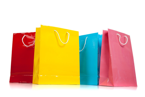 Assorted colored shopping bags on white - Valokuva, kuva