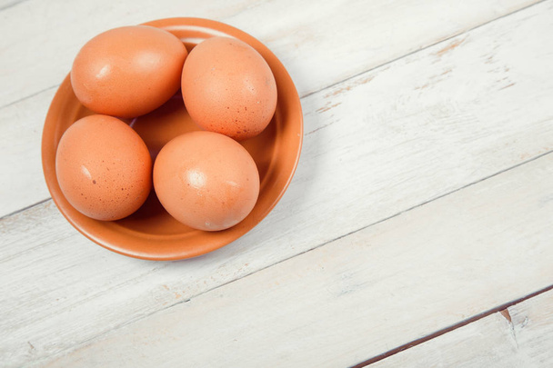 Raw chicken eggs on wooden background - 写真・画像