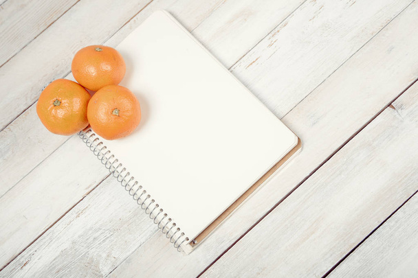 Tangerine (mandarin) with blank notebook - Photo, Image