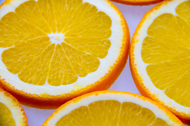 Sliced oranges lying on a light surface - Foto, afbeelding