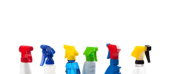 a row of assorted cleaning trigger bottles with copy space - Foto, immagini