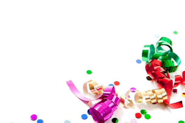 Multi colored confetti and streamers on white - Фото, изображение