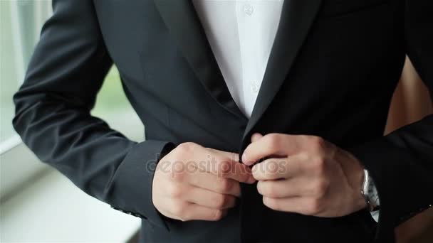 Stylish man dressed in suit buttoning jacket close up. Male hands of confident gentleman adjust outfit preparing for formal evening. Image establishment leadership lifestyle masculinity style success  - Footage, Video