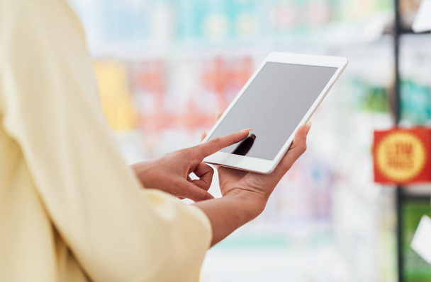 Woman  checking offers on digital tablet - Foto, Bild