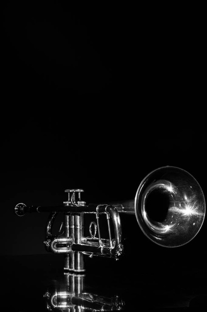 lonely musical instrument which is a trumpet on a black background - Φωτογραφία, εικόνα