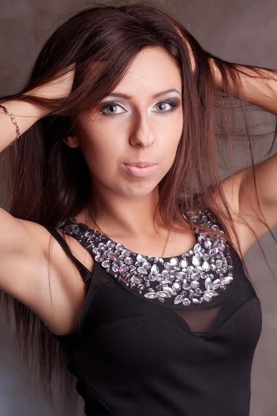 Beautiful girl in a black dress with sequins - Foto, imagen