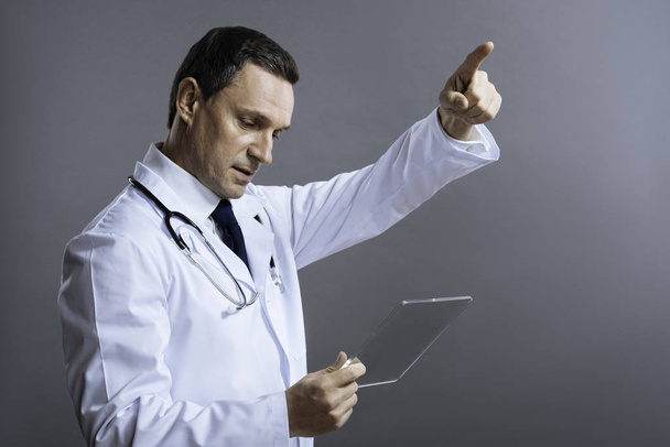 Handsome doctor gesturing with medical glass - Фото, зображення