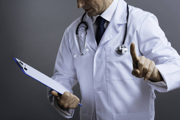 Close up of smart doctor holding documents - Foto, Bild
