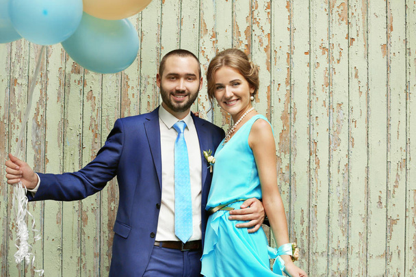 Portrait of bridesmaid and best man with balloons on wooden background - 写真・画像