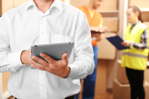 Young businessman with tablet at warehouse - Foto, Bild
