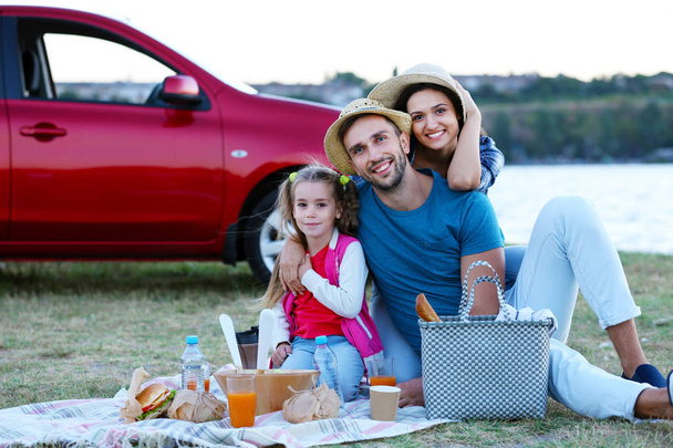 Happy family on picnic outdoors - Foto, afbeelding