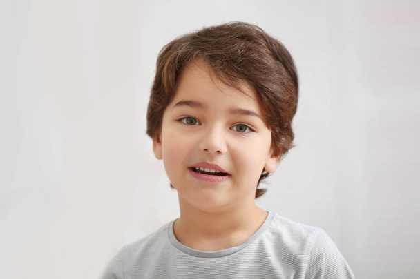Cute emotional little boy on light blurred background - Photo, image