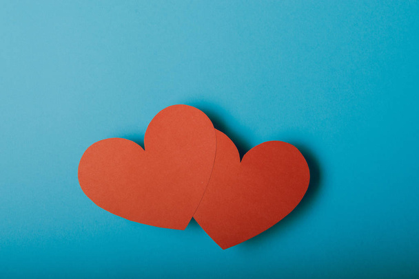 Red paper Valentines Day heart against a blue background - Photo, Image