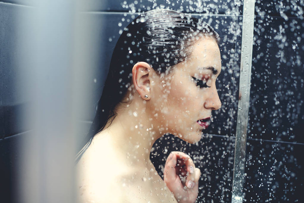 Beautiful sexy  young woman washing body in a shower - 写真・画像