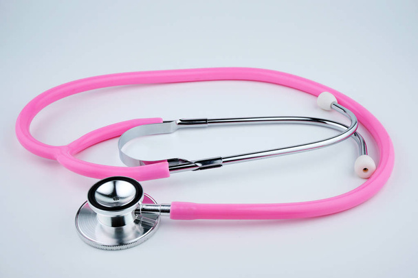 Pink stethoscope on white background. - Zdjęcie, obraz