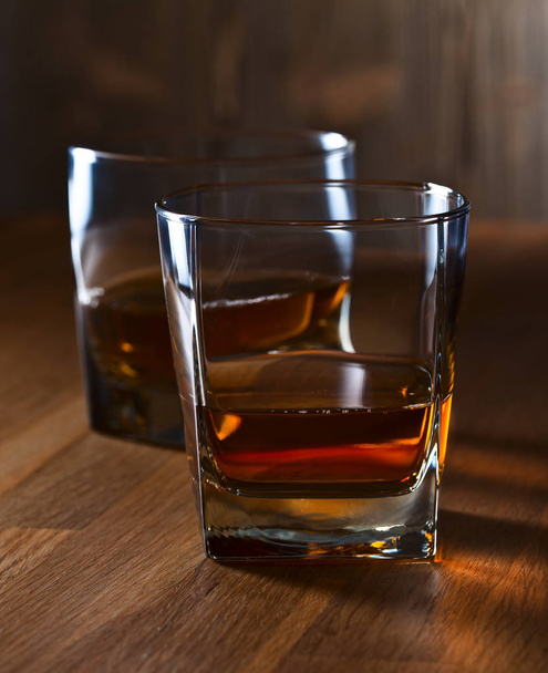 glass of whiskey on wooden table - Φωτογραφία, εικόνα