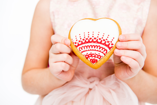 Girl holding heart shaped cookie  - Fotografie, Obrázek