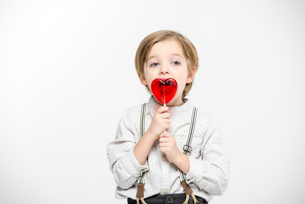 Boy with heart shaped lollipop - Фото, изображение