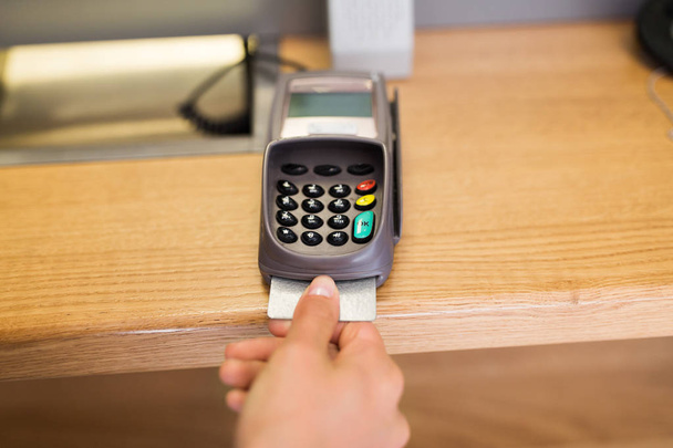 close up of hand inserting bank card to terminal - Zdjęcie, obraz