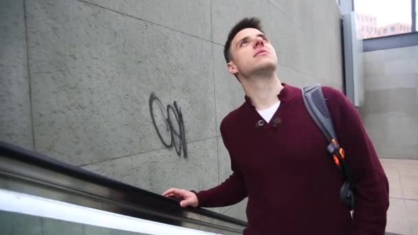 Young man on the escalator - Filmati, video