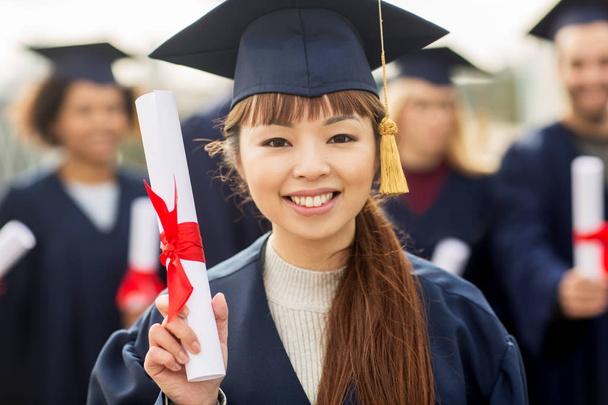 close up of happy student or bachelor with diploma - Фото, зображення