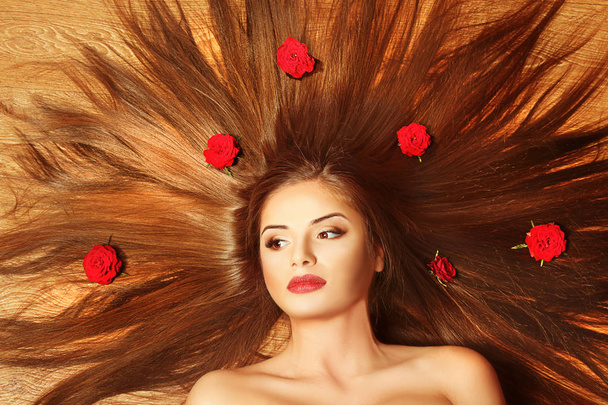 Beautiful girl with healthy hair and rose, closeup - Photo, image