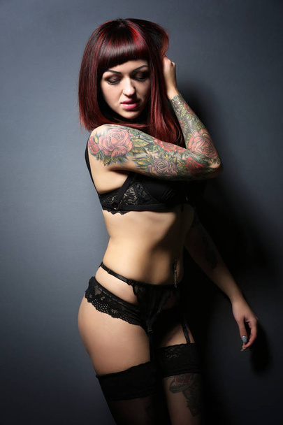 Beautiful girl with tattoo in black lingerie - Foto, Imagen