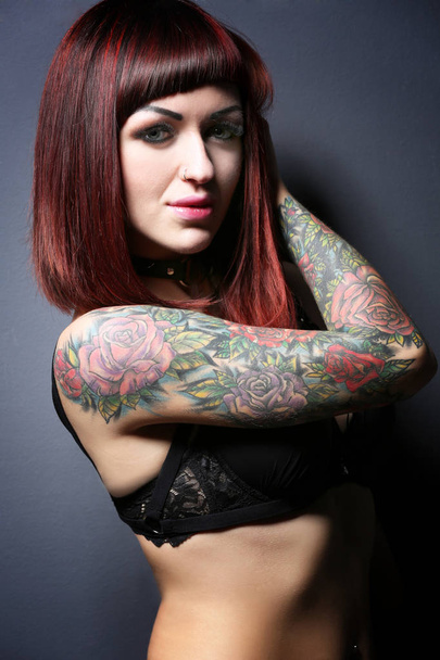 Beautiful girl with tattoo in black lingerie - 写真・画像