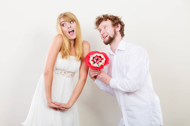 Happy couple with candy bunch flowers. Love. - 写真・画像