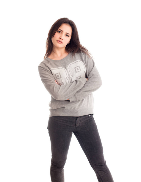 Angry girl in jeans and sweater isolated - Fotó, kép