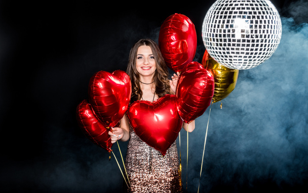 Beautiful woman with shiny balloons - 写真・画像