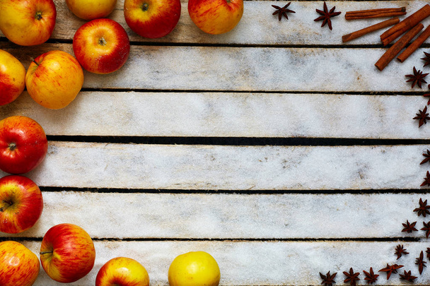 Some red and yellow apples on the white wooden table - Photo, image