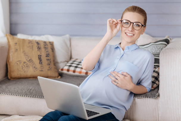 Pregnant woman wearing glasses and relaxing - Foto, Imagen