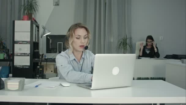 Customer support operator working in a call center office - Video, Çekim