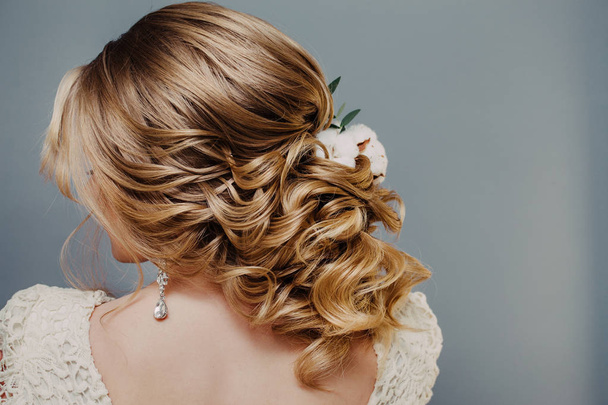 Visão traseira close-up dos penteados de casamento acabados na forma de noiva de inverno com decoração de flores de algodão
 - Foto, Imagem