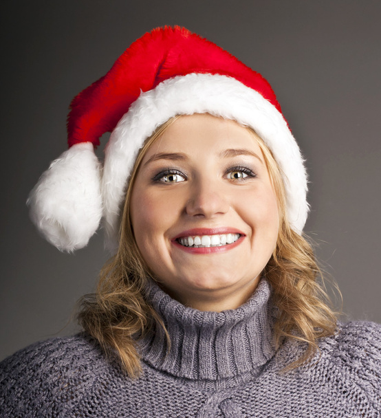 Beautiful smiling young Santa hat in studio - Photo, image