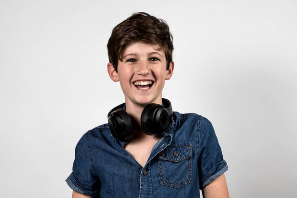 Teenage boy listening to music laughing white background - Photo, Image
