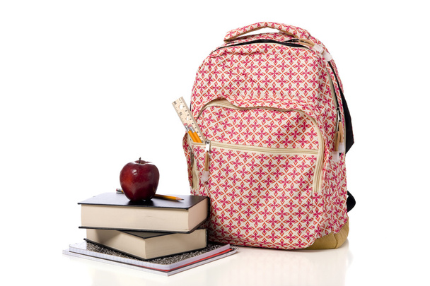 Pink Patterned Back Pack with supplies and an apple - Zdjęcie, obraz