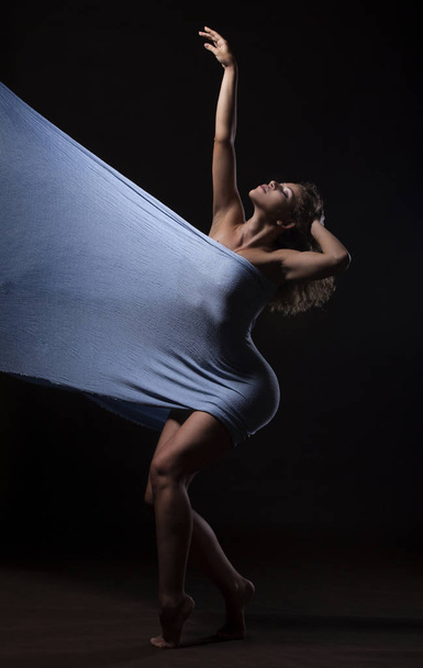Beautiful young girl dancing with blue fabric - Photo, Image