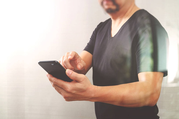 Designer hand using smart phone for mobile payments online shopp - Foto, afbeelding