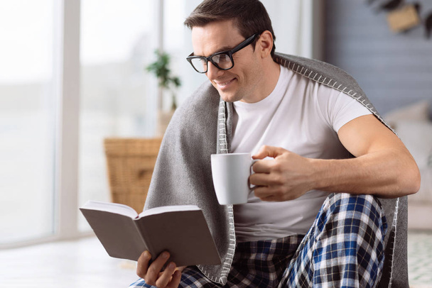 Intelligent handsome man reading a book - Photo, Image