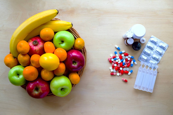 Colorful fresh fruits and pills. Healthy lifestyle concept. - Fotografie, Obrázek