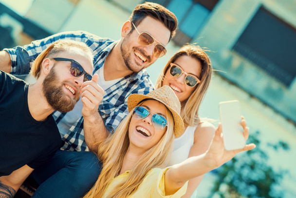 Group of cheerful young people taking selfie - Fotografie, Obrázek