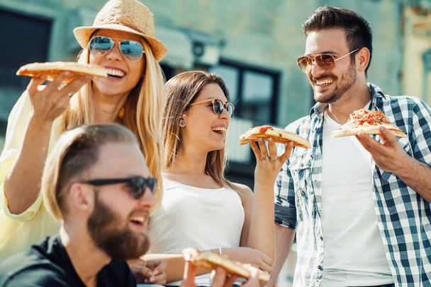 Group of friends taking their slices of pizza - Photo, Image