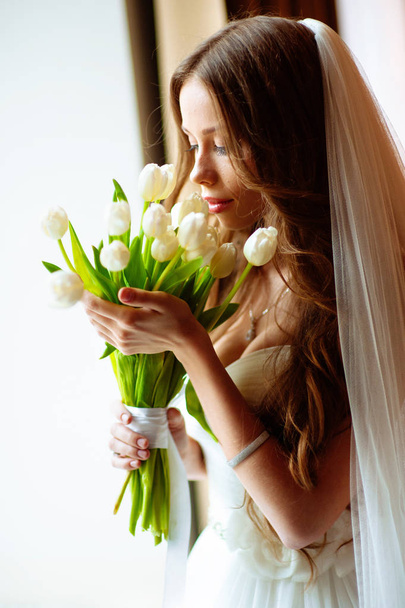 Bride in wedding dress at luxurious suites. Bride in a luxury apartment in a wedding dress. - Valokuva, kuva