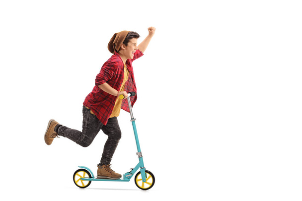 boy riding a scooter and gesturing with his hand - Φωτογραφία, εικόνα